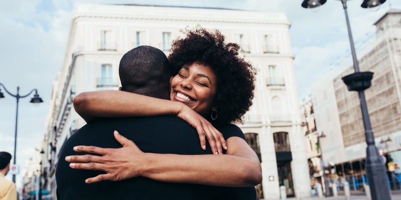 Happy african american couple hugging