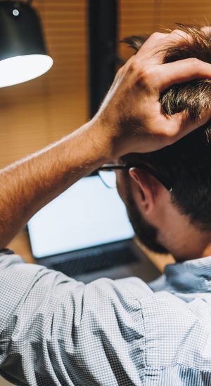 Young stressed businessman in a panic in front of a computer in office. Young stressed businessman in a panic in front of a computer in office.